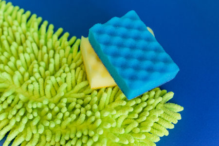 composition with dishwashing sponges and microfiber rags on blue background, copy space. Home Care Concept.Detergents and cleaning accessories. Cleaning service concept.Washing,cleaning equipment.の写真素材