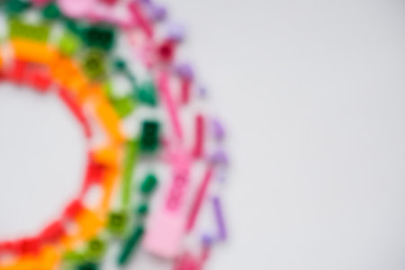 blurred, defocused colorful plastic bricks and blocks on white background ,top view ,space for text. Educational toy for children. Developing children games frame. Copy spaceの写真素材