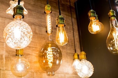 Beautiful retro luxury light lamp decor glowing.House interior of loft and rustic style. vintage light bulb hanging decor glowing in dark. Blend of history and modern.incandescent Edison type bulbsの写真素材