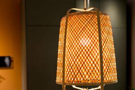 Decorating hanging lantern lamps in wooden wicker made from bamboo.Beige boho interior of living room, elegant accessories, hanging rattan hut in stylish home decor.の写真素材