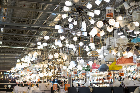 Russia, Moscow, 02.01.2021. Lusters and lamps exhibited in the store for sale.Many of imported chandelier from Europe selling in department store with many kind of colors and shape. Modern chandelierのeditorial素材