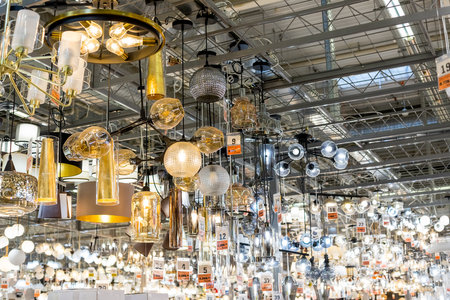 Russia, Moscow, 02.01.2021. Lusters and lamps exhibited in the store for sale.Many of imported chandelier from Europe selling in department store with many kind of colors and shape. Modern chandelierのeditorial素材