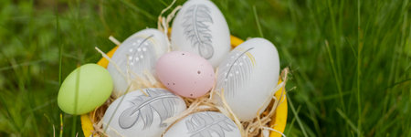 easter holiday concept. Easter decor with bright painted eggs in grass. web banner. template for...
