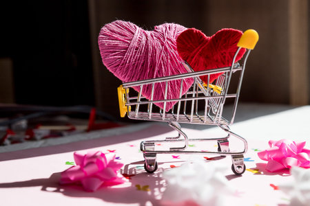 Big red heart in a shopping cart. Concept for buying love.Valentines Day online Shopping.trolley with hearts. Romantic presents for wedding, womens day, buying gifts Valentine Day for lovers.の写真素材