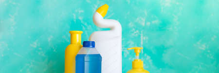 Variety of colorful house cleaning products on blue background.Bottles with detergent. web banner.Household cleaning.sanitary supplies.Copy spaceの写真素材