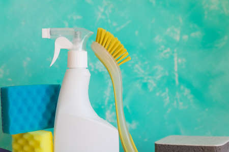 Cleaning product, household, sanitary supplies.Variety of colorful house cleaning products on blue background.Clean up and spring-cleaning concept.Bottles with detergent, brush, sponge and glovesの写真素材