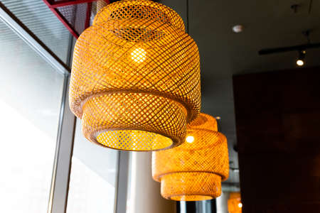 Decorating hanging lantern lamps in wooden wicker made from bamboo.Asian style.Pendant light with wicker lampshade, rustic style.の写真素材