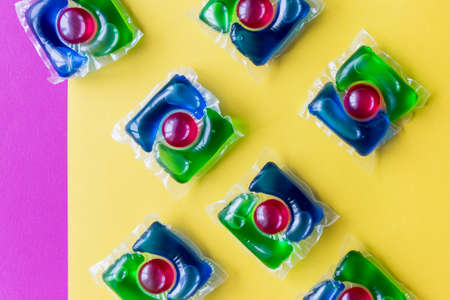 Blue laundry detergent sorts variety in powder, liquid gel and pod in washing dose.Liquid pods with gel and softener in blue and green.Laundry capsules.Copy spaceの写真素材