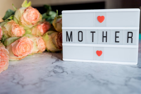 lightbox with message Happy Mothers day and mock up wooden frame, colorful roses on marble background.roses ,red hearts with text mother.Beautiful present concept.Congratulationsの写真素材