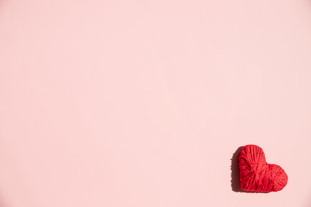red heart ,decoration on pink background. Love concept. Flat lay.Top view of romantic symbol of valentines day for background use. Concept of love, romance, and passion. Minimal Valentine concept.の写真素材