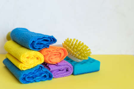 housework, housekeeping and household concept,cleaning stuff on white background.bottle of detergent, rubber gloves with rag ,sponge.domestic cleaning sanitary supplies.Copy spaceの写真素材