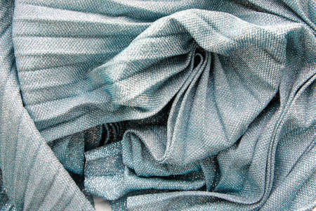 Glamor shimmering background.Silver sparkling ,Festive abstract shiny background with flashing lights. The fabric glitters,bright color.fabric texturep. Metallic glitter blue, grey cloth textureの写真素材