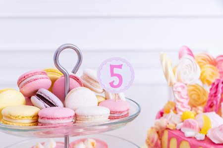 French macaroons on a cake stand .Candy bar with macaron, cakes, cheesecakes, cake pops.Colorful...