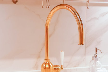 Retro faucet in bronze in the bathroom of the hotel. Sanitary prevention antivirus concept....