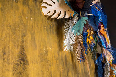 Creative layout with colorful tropical leaves on golden background. Minimal summer exotic concept. Flat lay, copy space. Border arrangement.elegant trendy summer background.の写真素材