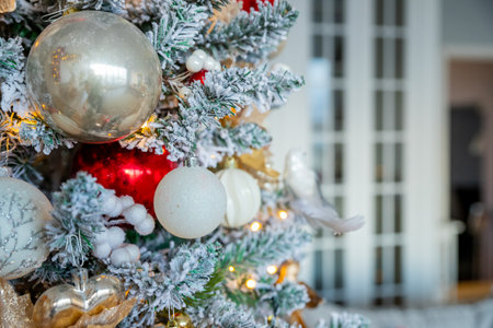 Amazing glittering christmas tree with balls, toys and ribbons decorations. Christmas baubles with star shaped lights on a Christmas tree.happy holidaysの写真素材