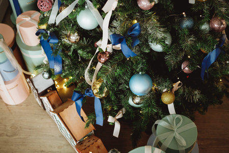 Christmas tree with toys in blue and golden color.christmas tree in living room, decorated with blue ornaments and garland, lots of presents under the tree.winter holidaysの写真素材