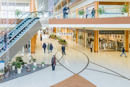 moscow,russia -January 27, 2022: People Shopping in mall, wearing protective or medical face masks due to Covid-19 coronavirus.Shopping in the coronavirus pandemic.People, sale, black friday concept.のeditorial素材