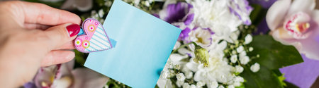 greeting card mockup scene with womans hand holding blank paper card. Bouquet of beautiful flowers....
