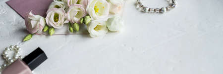 Beauty blog concept. Accessories, flowers, cosmetics and jewelry on white background. Womens Day concept.Woman fashion accessories, Eustoma, cosmetics and jewelry on pink background, copyspace.の写真素材