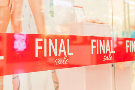 final SALE white word on red Fabrik backdrop in shop window. Summer sale. special offer, big sale concept. Discounts shopping.shopping time.の写真素材