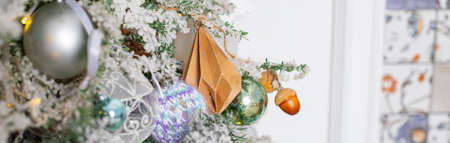 Christmas holiday, fir branches, conifer cones, silver, blue, white ornaments.Decorated Christmas tree.Glittering ball for new year. web bannerの写真素材