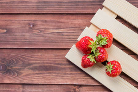 Fresh ripe organic strawberry on a dark wooden background. Top view with copy space. summer foodの写真素材