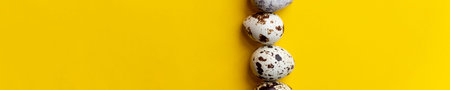Top view ,Row of small speckled Quail eggs on yellow background. Minimal Happy Easter...