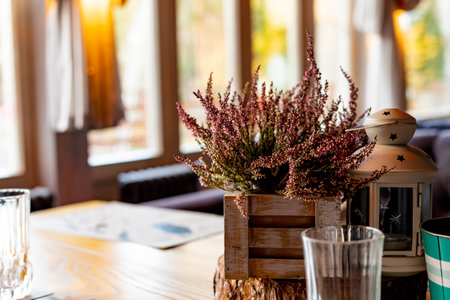 Autumn still life in the cafe, at home. Heather, white lantern, spikelets in wooden boxes, cozy...
