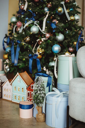 Gift boxes under the Christmas tree close-up. Gifts near the Christmas tree in blue, pink and white...