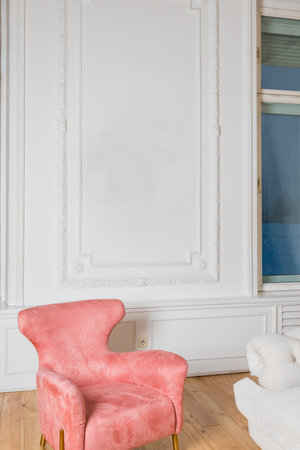 Minimalistic and luxury pastel pink home interior with velvet design armchair, big window.classical style Armchair in vintage room. house interiorの写真素材