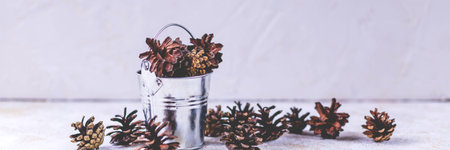 Christmas.dry pine cones in white ceramic cup on white background, composition. Creative flat...