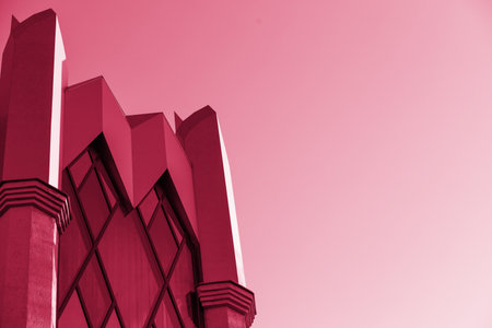 Glass modern building, skyscrapers. A simple architectural form against the sky.Fragments of modern urban architecture.Geometric details. Image toned in Viva Magenta,2023 year. copy spaceの写真素材