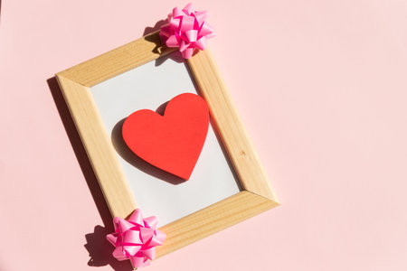 wood frame with Valentines Day heart decor and calendar. Copy space.Valentine gift diy hobby. Happy lovers day cardの写真素材
