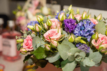 Beautiful bouquet of fresh pink roses, hyacinth, eucalyptus in tender pink and blue colors, bouquet of flowers close up. Floral shop concept.flowers wedding decorationの写真素材