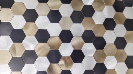 Honeycomb shape colorful decorative ceramic tiles on wall.Gray, bronze and black tiles on the floor. Hexagon patterns.wall with textured hexagons.の写真素材