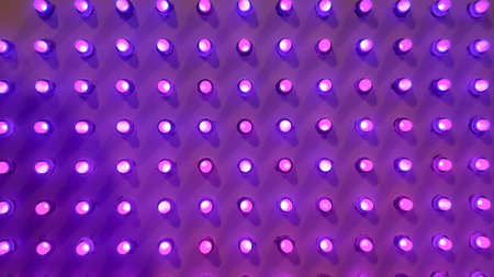 purple Disco wall background in neon led dot lighting.pipes and lamps on the wall. light bulbs pattern.LED decoration lights idea on wall.modern decoration.の写真素材