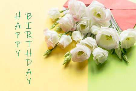 composition with bouquet with eustoma, envelope. Floral decorative elements on yellow background.Happy birthday Day concept. text. Eustoma flowersの写真素材
