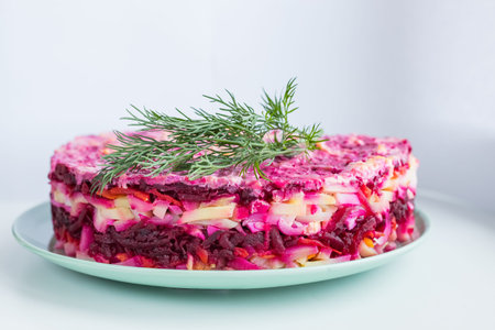 Russian salad - herring under a fur coat, herring salad with potatoes, eggs, beets, carrots, and...