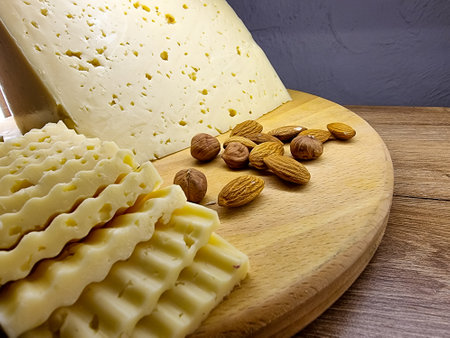 Variety of cheese on plates.Cheese platter with organic cheeses - blue cheese cheddar, emmantaler. wine appetizer with honey, grapes, pretzels .の写真素材