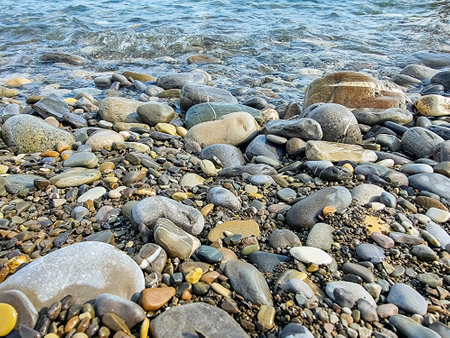 Stones on the beach and sea waterの写真素材