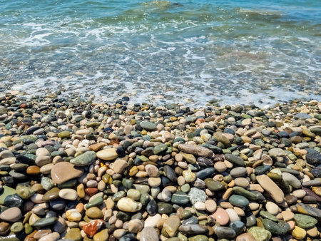 Stones on beach and sea water.Waves in sea near coastline on empty pebble beach. Coast pebbles. Shore landscape on Europe resort. Ocean shoreline scenic.の写真素材