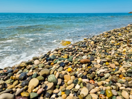 Stones on beach and sea water.Waves in sea near coastline on empty pebble beach. Coast pebbles. Shore landscape on Europe resort. Ocean shoreline scenic.の写真素材