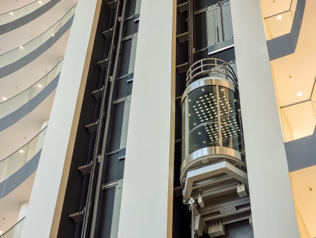 glass capsule elevator ,lift at luxury hotel or building.modern glass elevator to the upper floors, high building ,office and shopping mallの写真素材