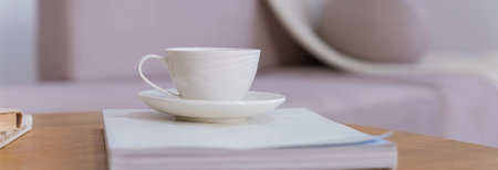 Work from home, renting apartment, buying. beige sofa with pillows, table with cup of hot drink, shelves in living room interior.Concept of morning cup of coffee, good start to the day, a cozy home.の写真素材