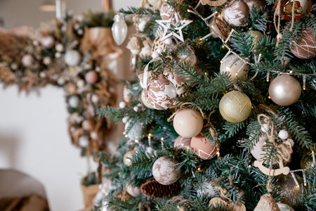 Christmas tree decorated with beige, brown and white balls and pinecone handmade Christmas zero-waste ornaments. Zero-waste Christmas decoration, paper and shiny decoration.の写真素材
