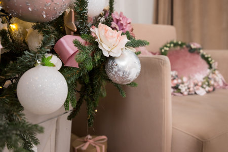 Garland, tinsel, pink and white christmas decorations balls hanging on a decorative christmas tree. Concept New Year celebration background.の写真素材