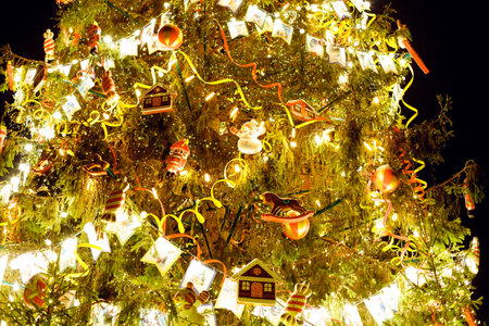 Atmospheric christmas eve in the night. Stylish new year tree with tinsel, retro decoration with golden lights and festive baubles.Merry Christmas. Magic winter holidays.copy spaceの写真素材