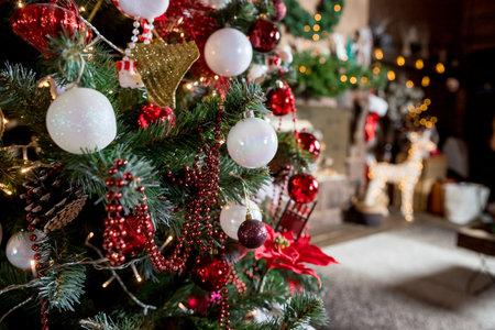 Beautiful new year room with decorated Christmas tree, gifts and fireplace with the glowing lights at night. The idea for postcards. decorated fir tree with garlands and ballsの写真素材