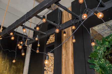 retro bulb hanging decoration for design purpose.Garland of Edison bulbs hanging on laces.garlands on the ceiling, interior and design concept. architectural lighting of the room in a retro styleの写真素材
